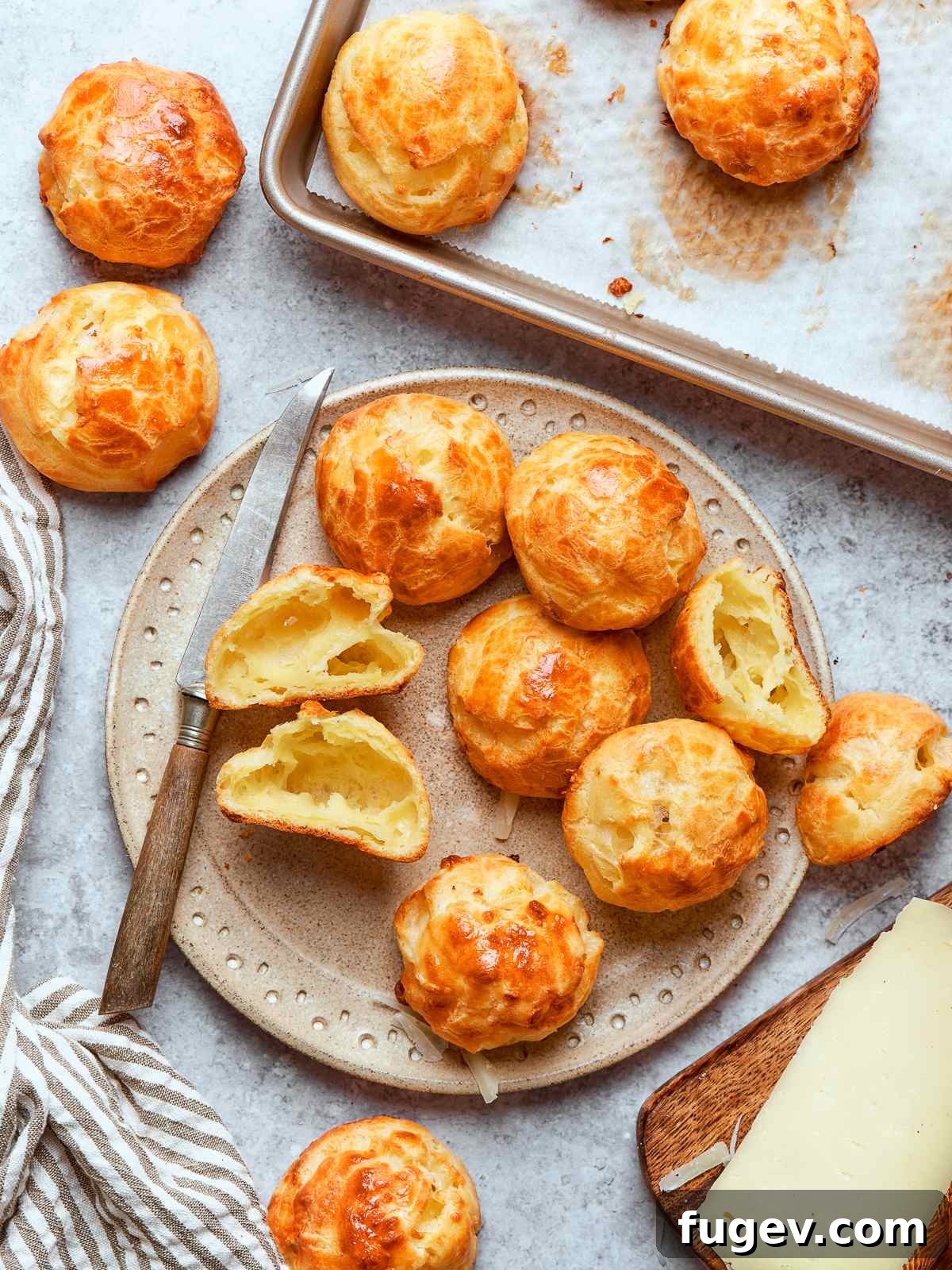 Golden Savory Puffs 2 Finished gougères puffed tall with crisp shells and evenly browned surfaces. A perfect batch of golden French cheese puffs ready to be served.