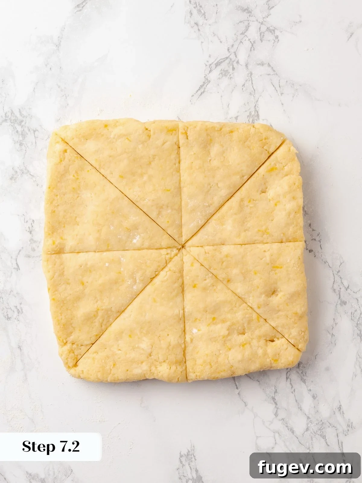 Sun-Kissed Lemon Scones 17 Dough meticulously divided into triangular shapes, showing clean cuts and consistent sizing, crucial for even baking results.