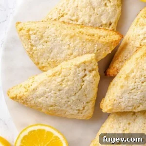 Lemon scones with golden brown edges and lightly crisp exterior from proper baking, presented to highlight their rustic charm.