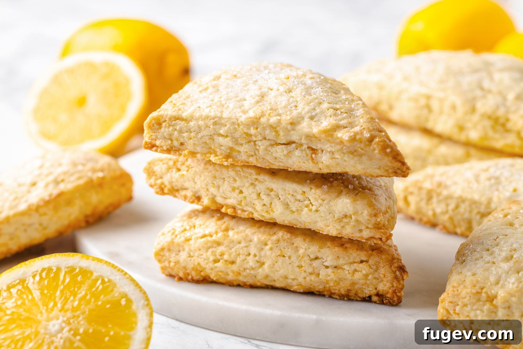 Sun-Kissed Lemon Scones 5 Fresh lemons alongside baked lemon scones highlighting the vibrant citrus ingredients used for their bright and refreshing flavor.