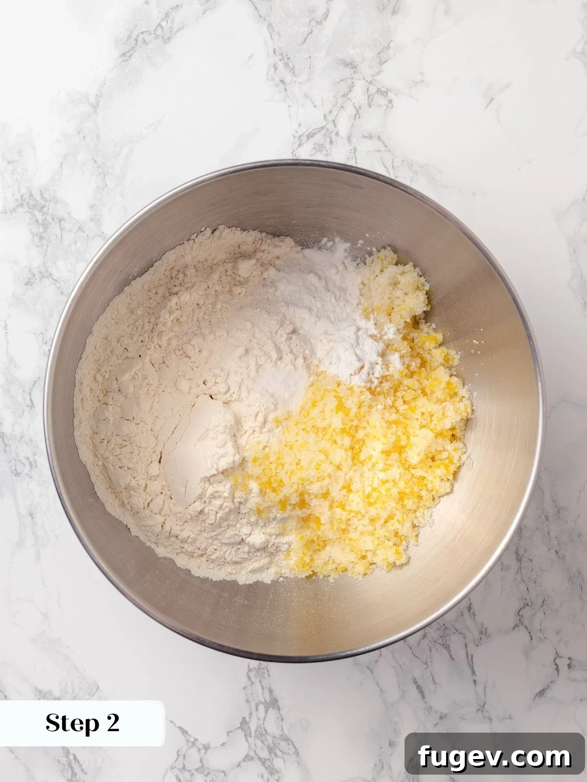 Sun-Kissed Lemon Scones 7 Dry ingredients, including flour, lemon-infused sugar, baking powder, and salt, are combined in a stand mixer bowl.
