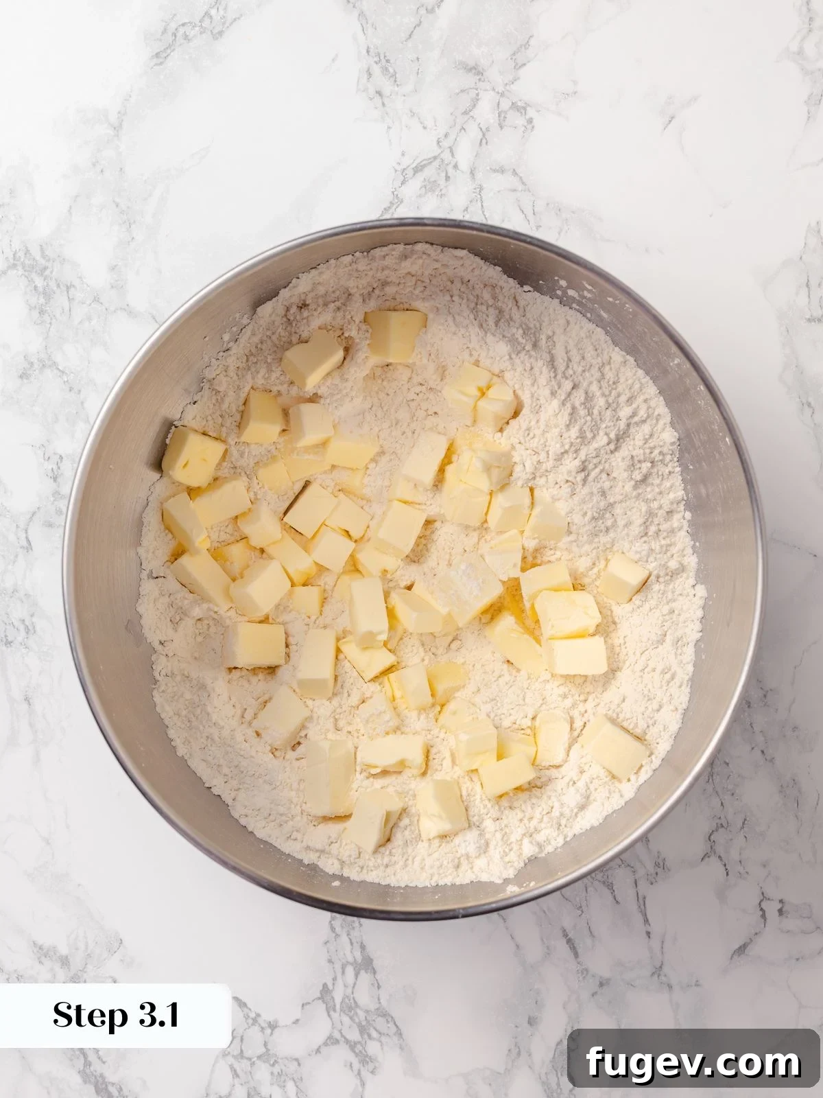 Sun-Kissed Lemon Scones 8 Cold butter being cut into the flour mixture until completely incorporated, forming a uniform texture like wet sand.
