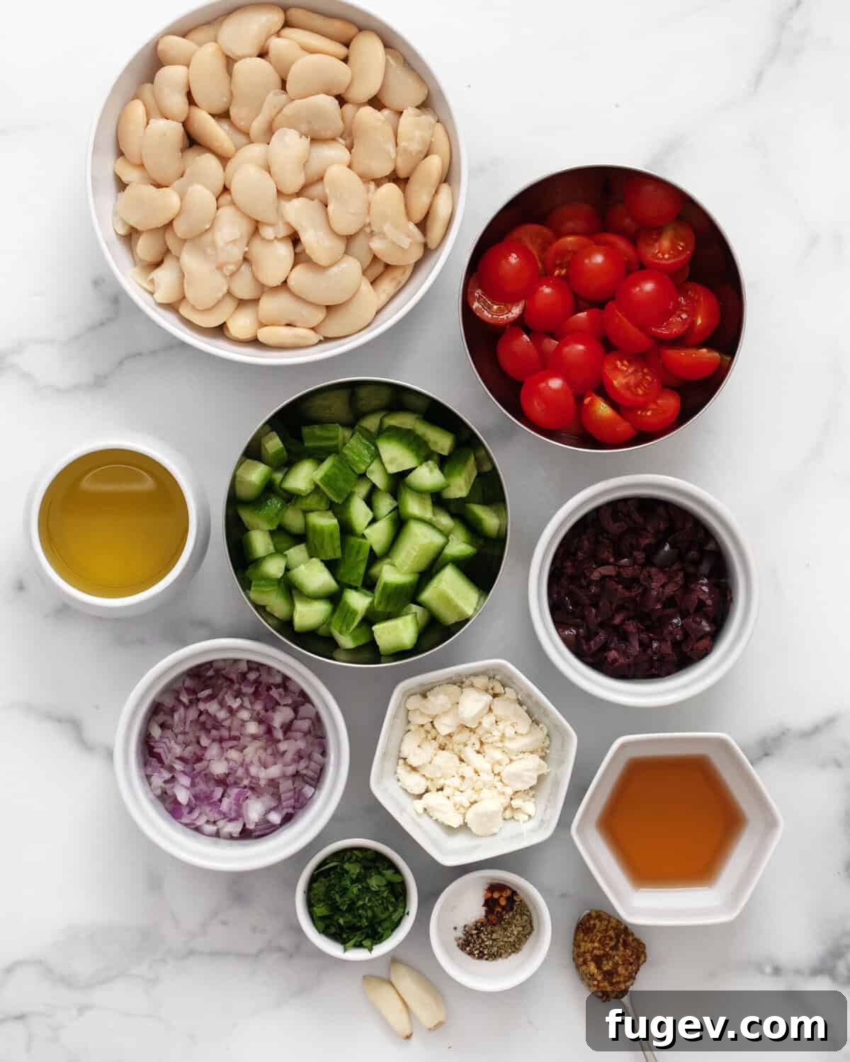 Ingredients including butter beans, cherry tomatoes, cucumbers, kalamata olives, red onions, feta, parsley, olive oil, red wine vinegar and seasonings.