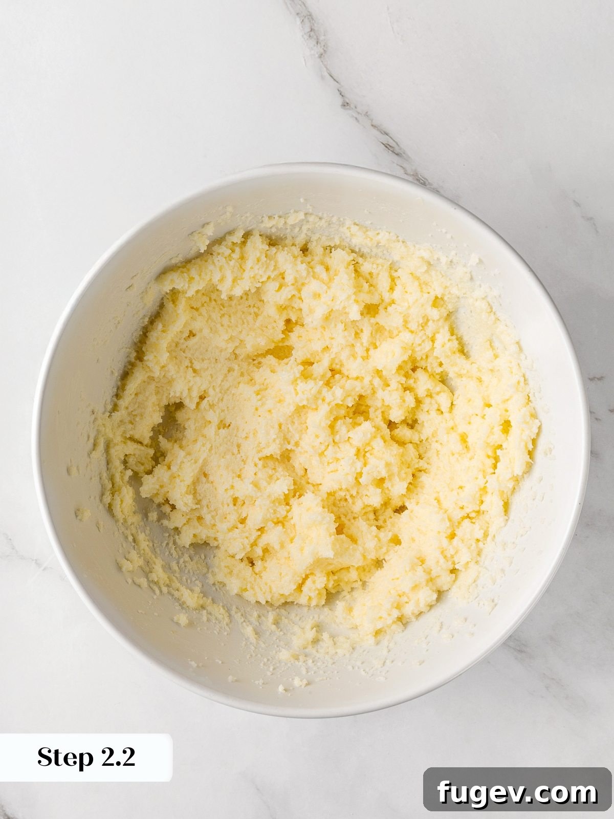 The butter and sugar mixture after being creamed until light, pale, and fluffy.