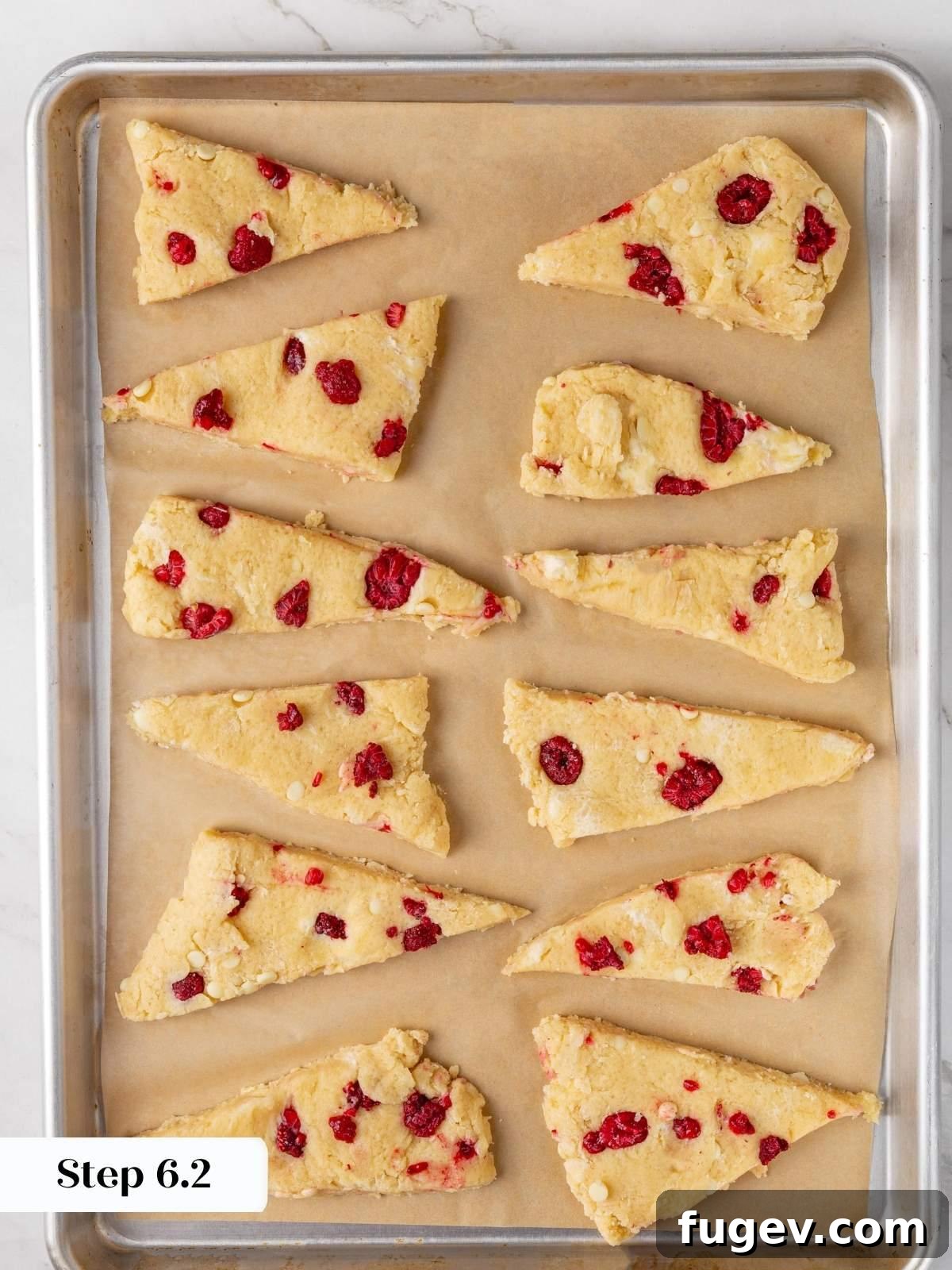 White Chocolate Raspberry Bliss Scones 16 The cut scones arranged on a parchment-lined baking sheet before going into the oven.