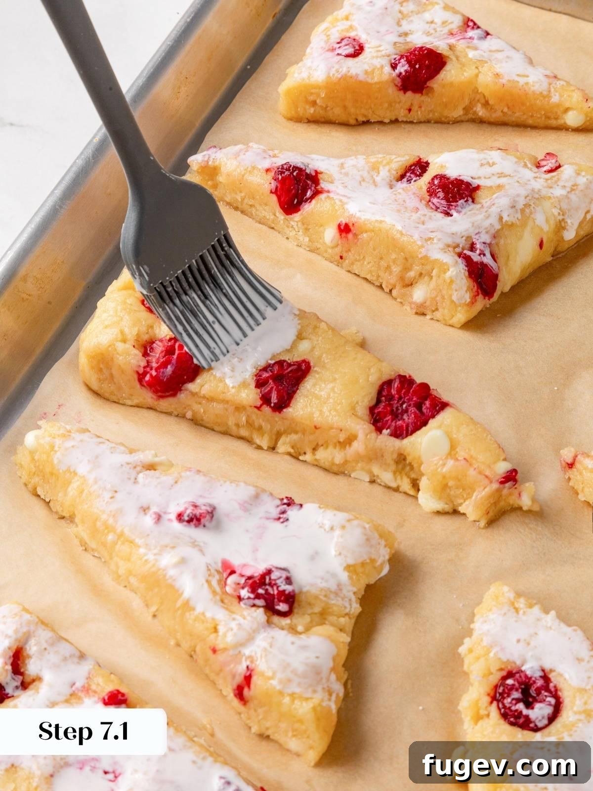 White Chocolate Raspberry Bliss Scones 17 Brushing the top of an unbaked scone with heavy cream using a pastry brush.