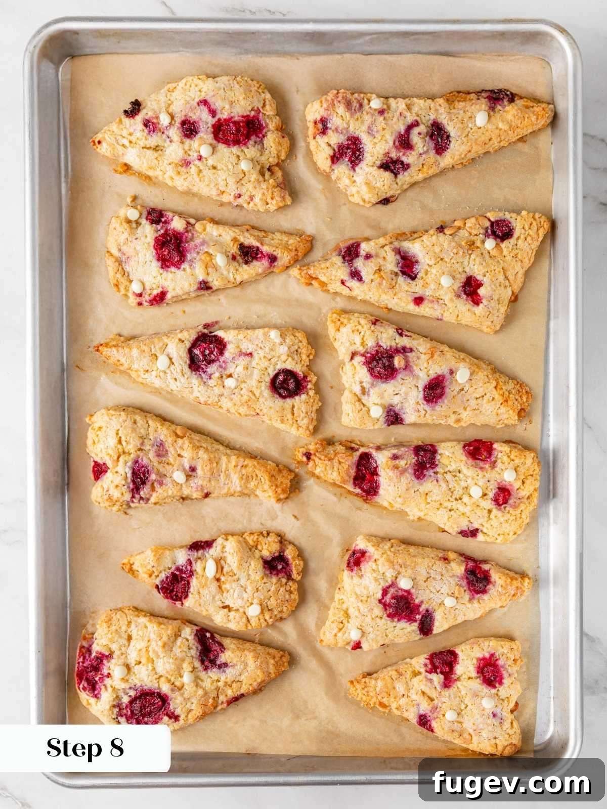 White Chocolate Raspberry Bliss Scones 19 The finished, perfectly baked golden scones on the parchment-lined baking sheet, fresh from the oven.