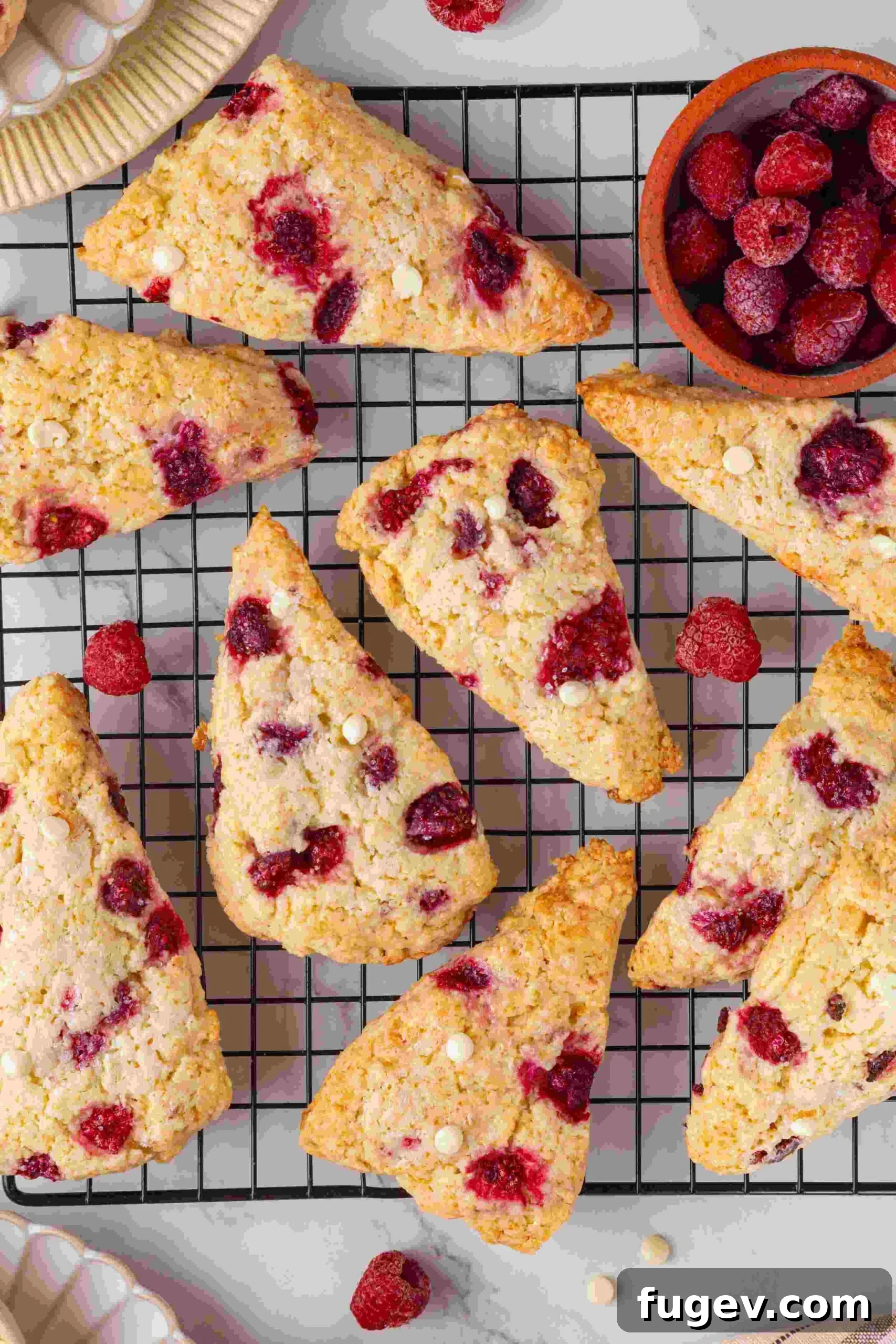 White Chocolate Raspberry Bliss Scones 20 An overhead shot of raspberry white chocolate scones on a wire cooling rack.