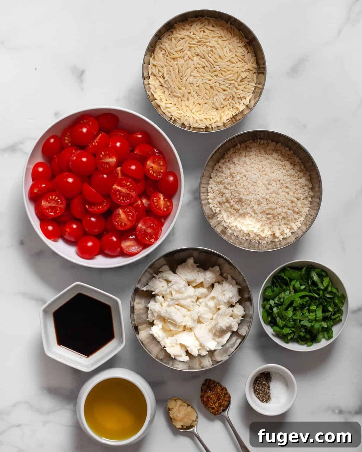 Ingredients including tomatoes, orzo, fresh mozzarella, basil, salt, pepper, balsamic vinegar, olive oil, mustard and garlic.