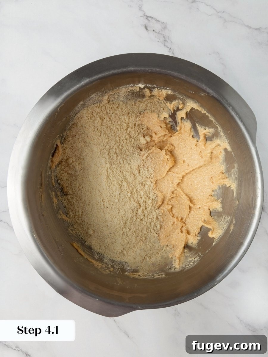 Adding the dry mix gradually keeps the almond flour chocolate chip cookies dough from turning greasy.