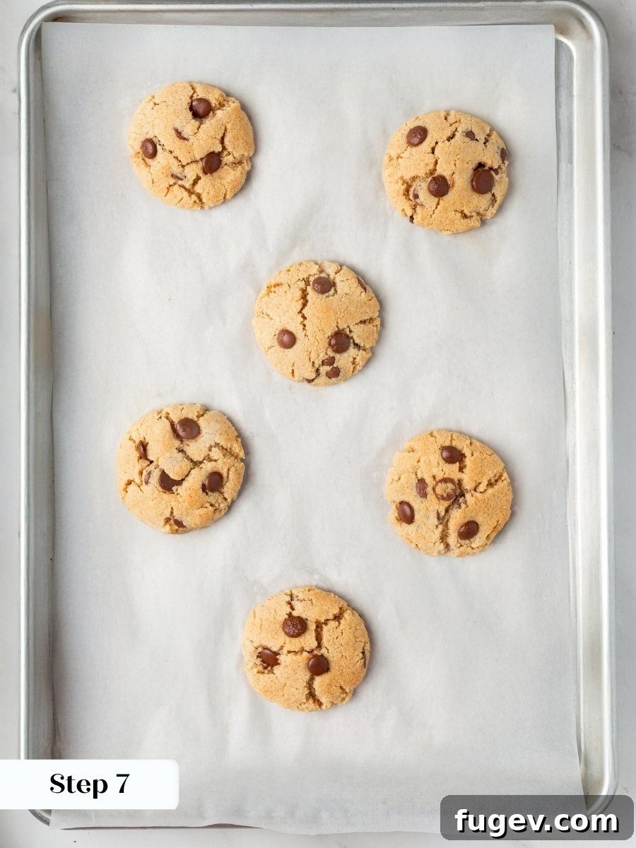 Crackled tops and matte centers tell you the almond flour chocolate chip cookies are perfectly baked.