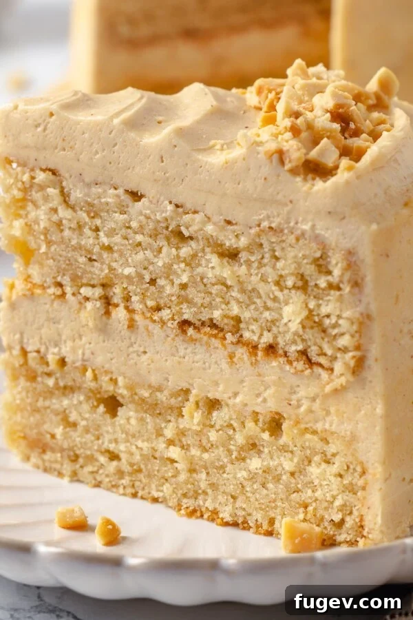 Slice of peanut butter cake showing tender crumb and frosting layers.
