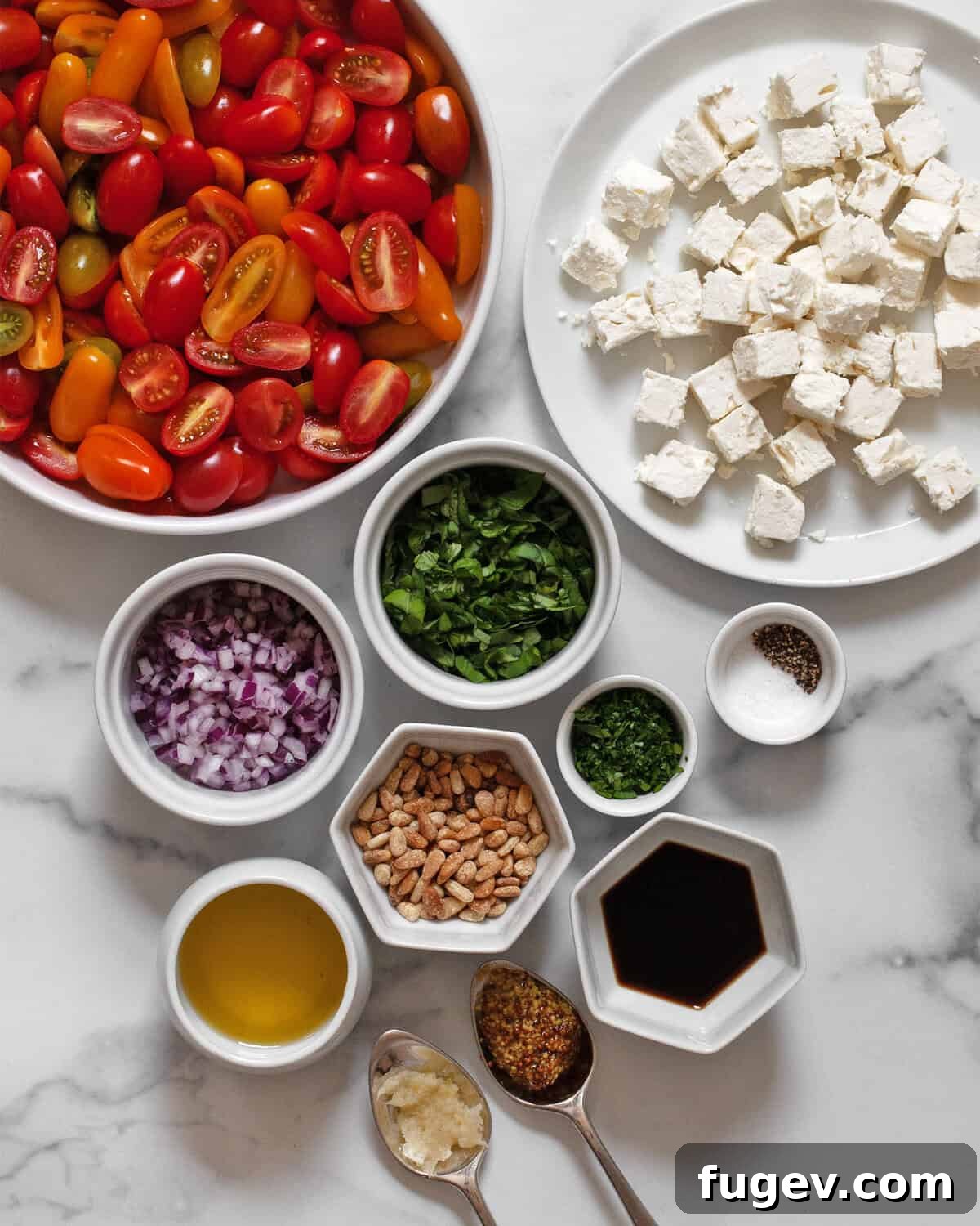 Ingredients including halved cherry tomatoes, feta, red onions, basil, parsley, balsamic vinegar, olive oil, garlic, mustard, salt and pepper.