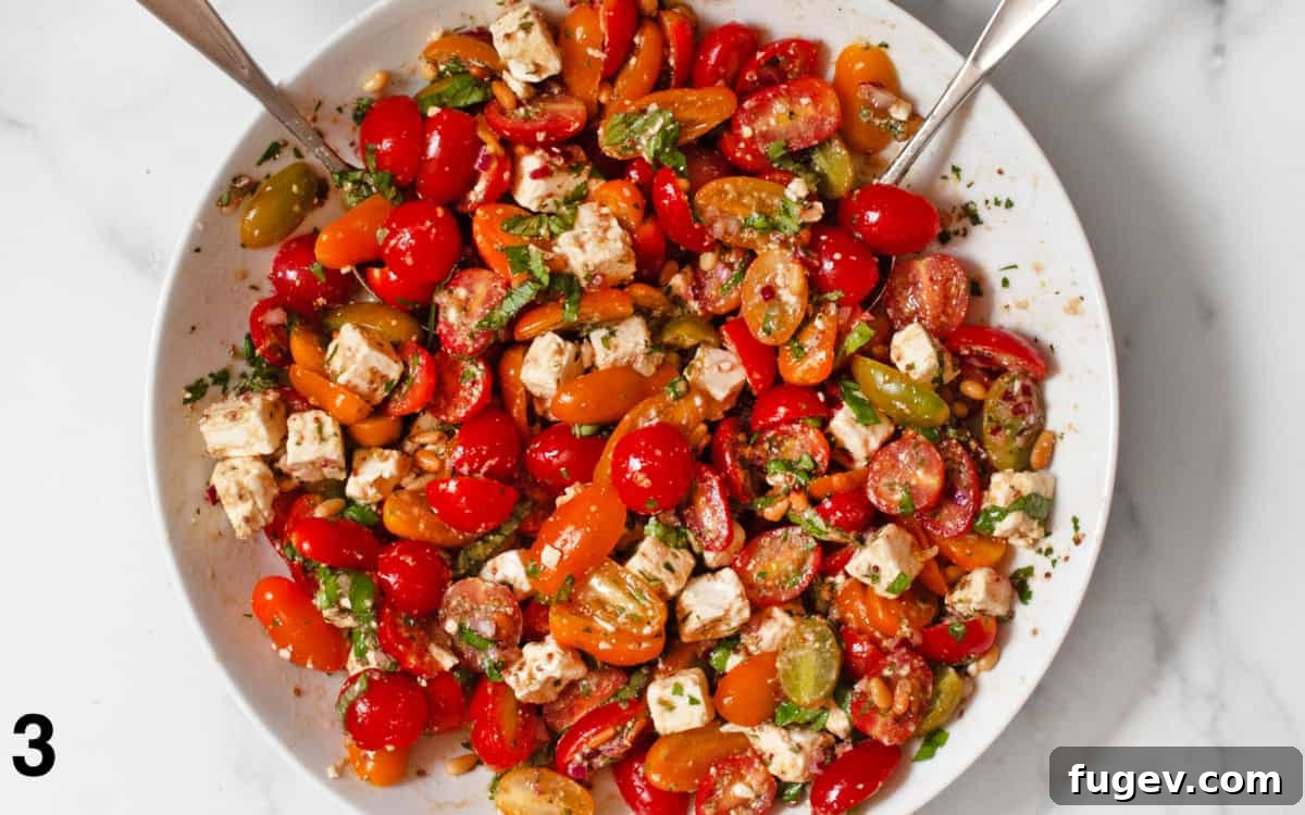 Basil and pine nuts stirred into tomato salad.