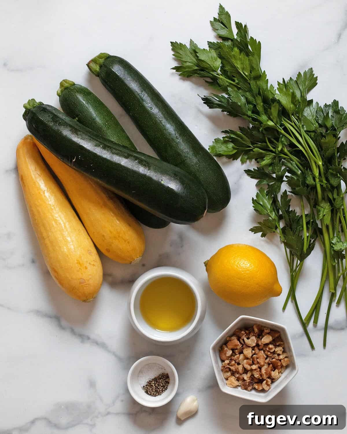 Ingredients including zucchini, yellow squash, parsley, walnuts, garlic, lemon, olive oil, salt and pepper.
