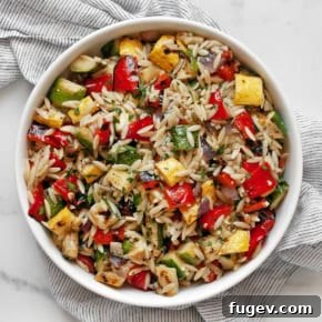 Grilled vegetable orzo salad in a bowl.