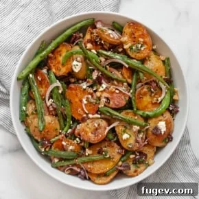 Roasted potato and green bean salad in a bowl.