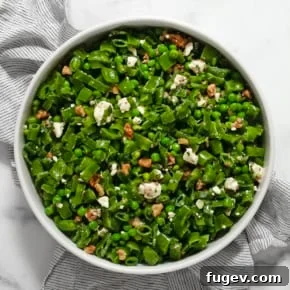 Three pea salad in a large serving bowl.