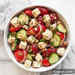 Strawberry cucumber feta salad in a bowl.