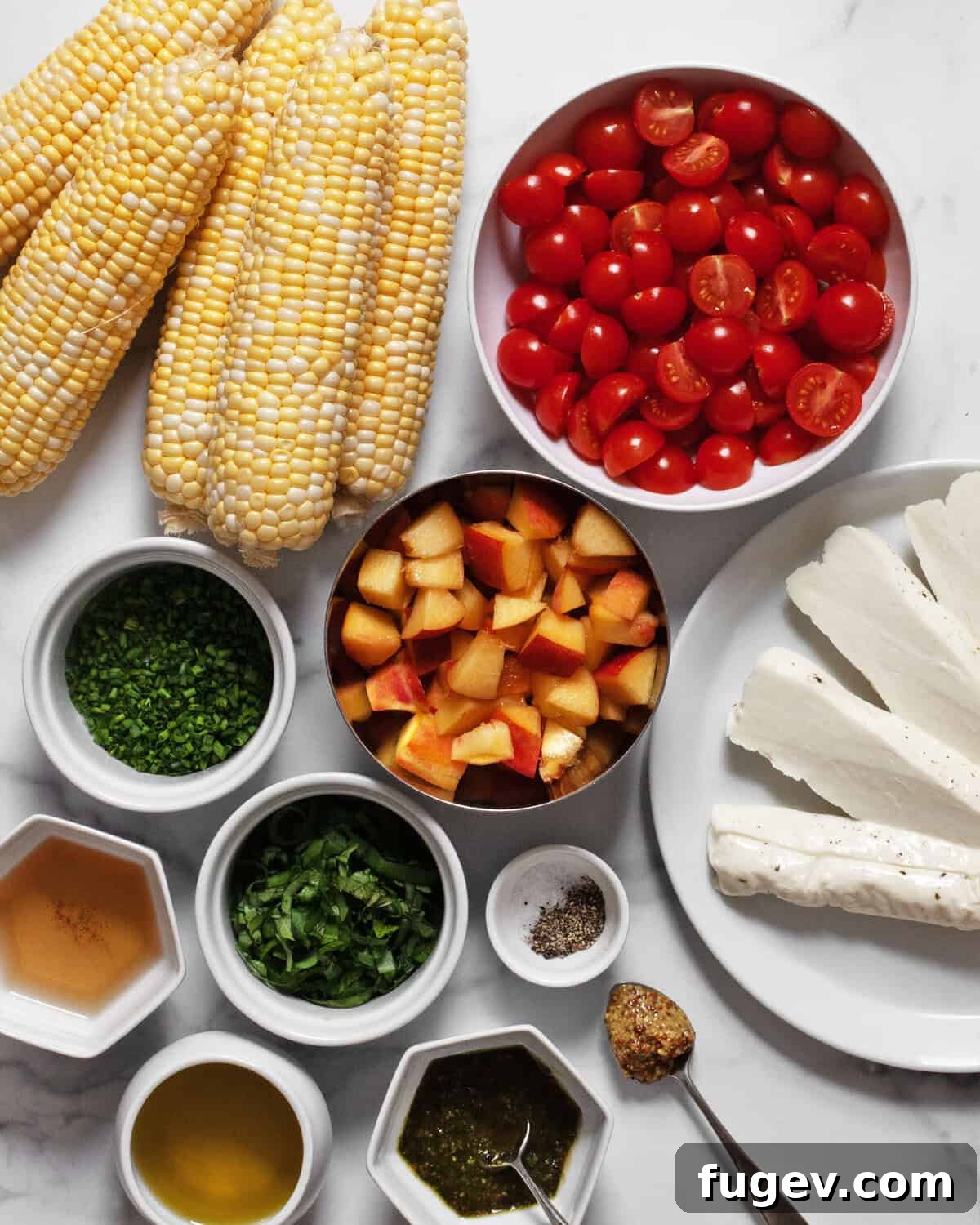 Ingredients including corn, peaches, tomatoes, halloumi, chives, basil, olive oil, mustard, white wine vinegar, pesto, salt and pepper.