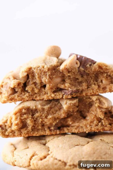 Loaded Reeses Peanut Butter Cookies stacked and sliced in half to see chewy texture.