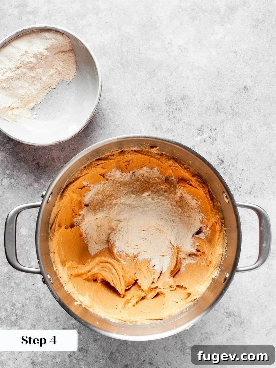 Adding flour in three stages gives better control over the final chewy peanut butter cookies texture.